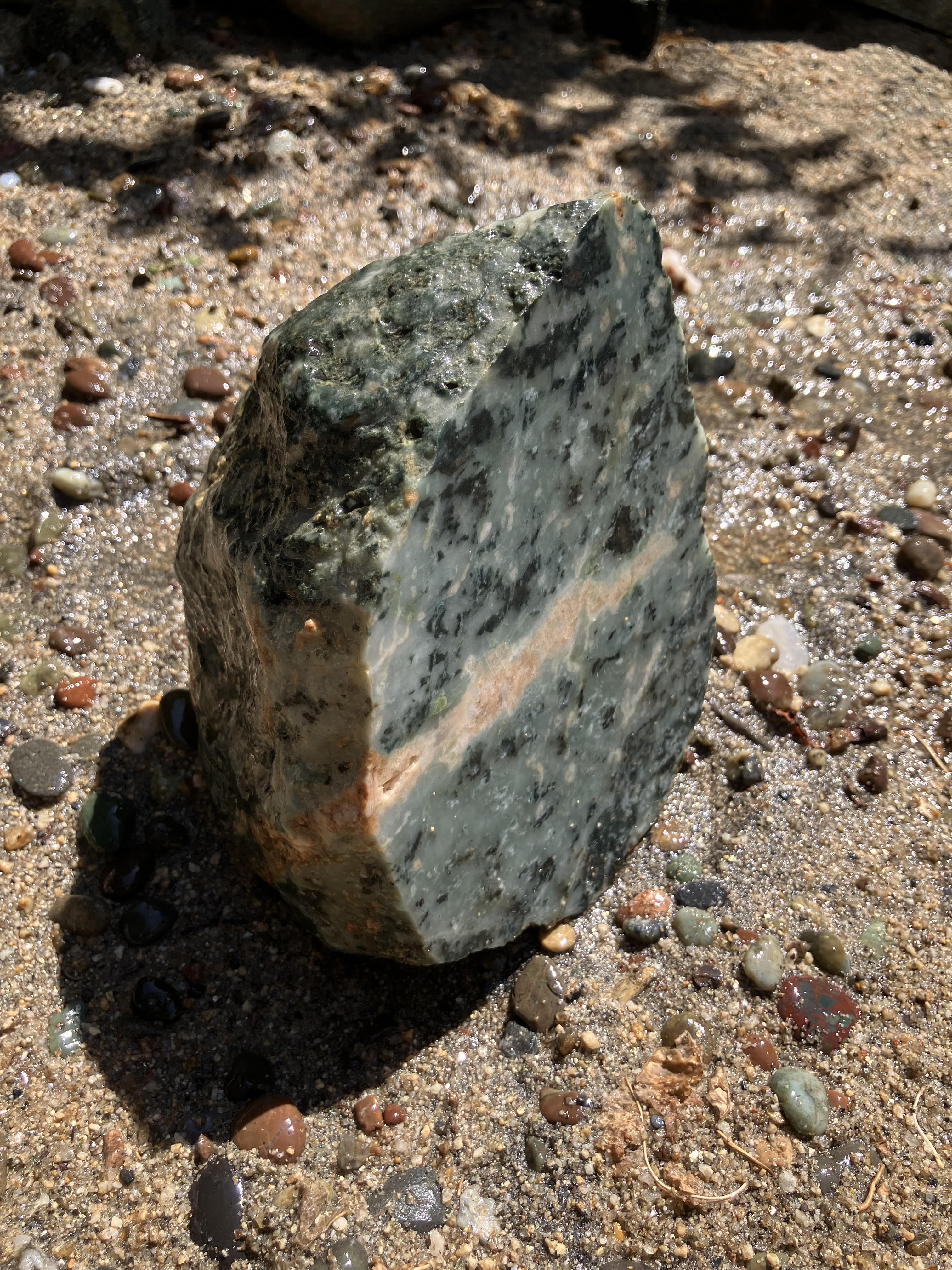 Mottled green jade specimen with a pale band