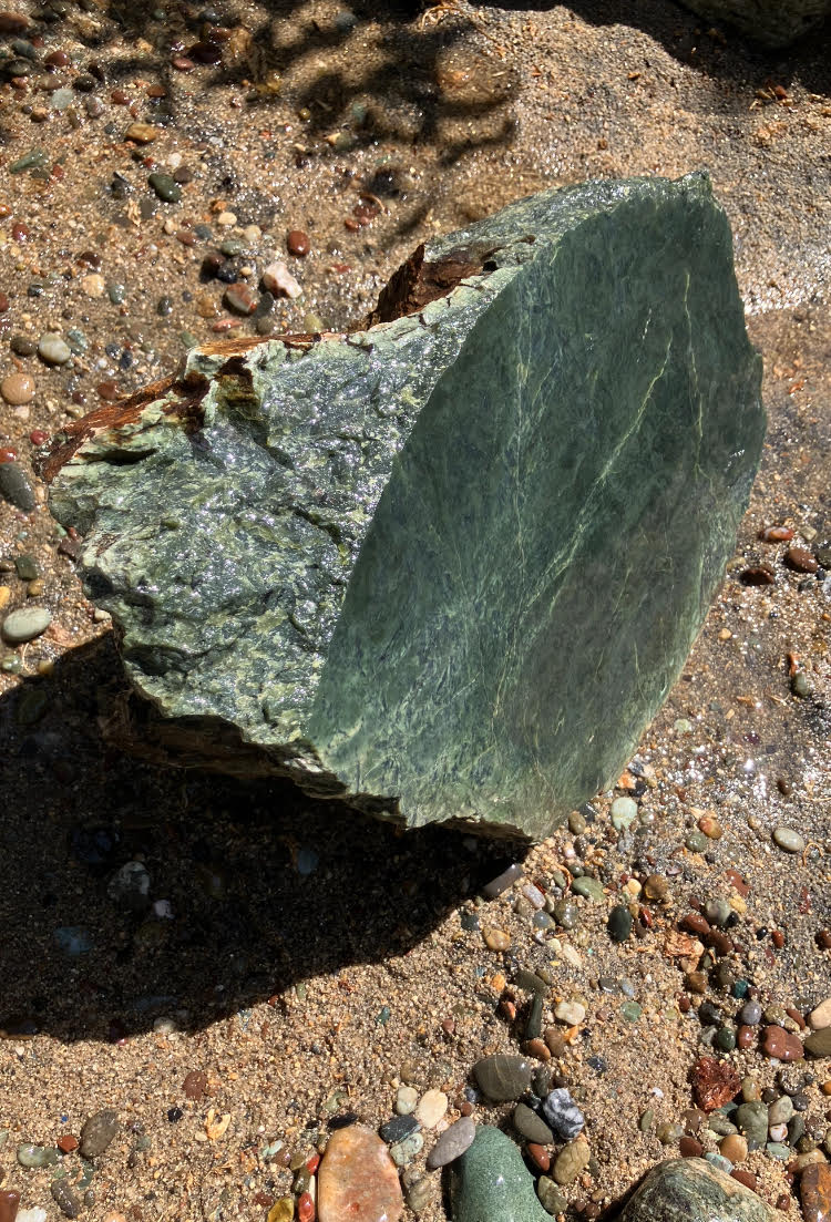 Green jade specimen with a flat face